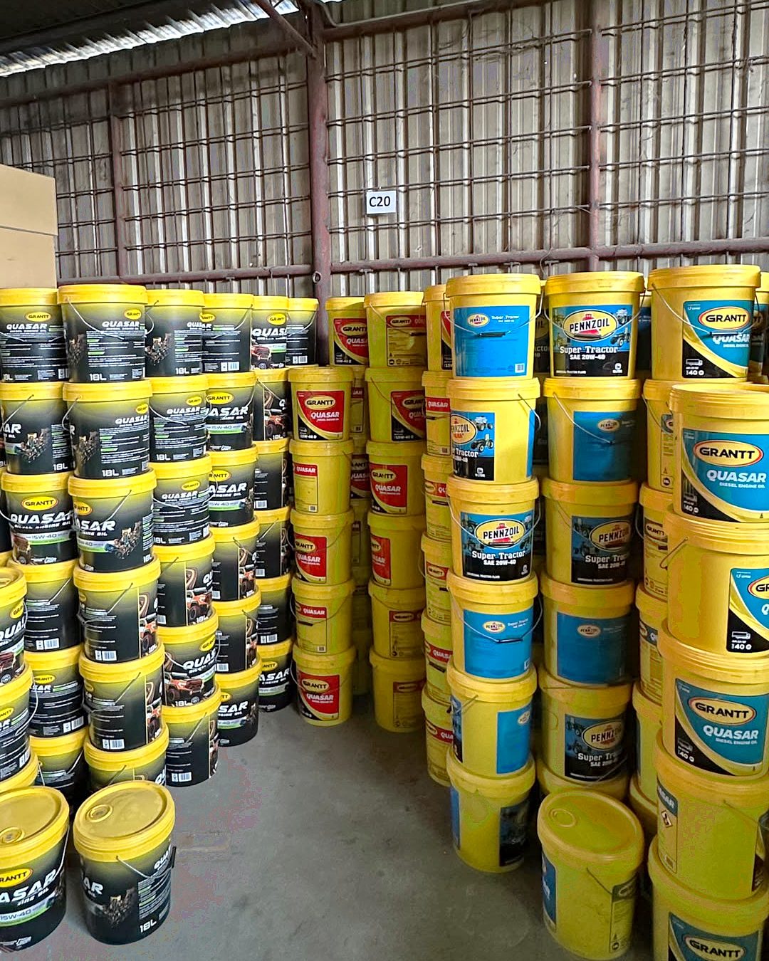 Stacks of Grantt and Pennzoil lubricant pails