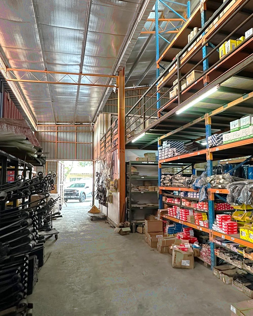 Warehouse with leaf springs and tall shelving