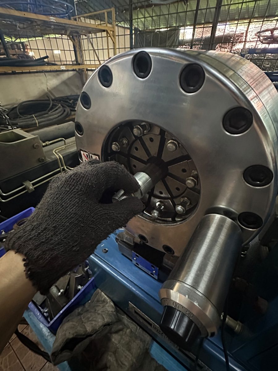 Crimping a hydraulic hose fitting at our workshop
